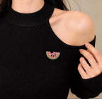 Pink and green crystal watermelon brooch pin worn on a black top